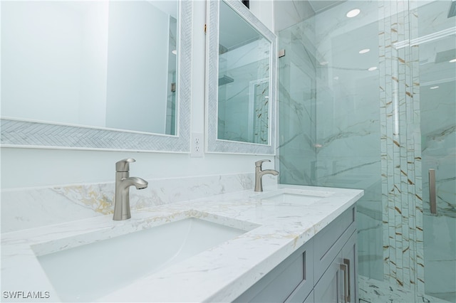 bathroom featuring vanity and an enclosed shower