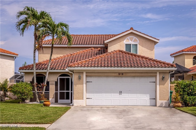 mediterranean / spanish home with a front yard and a garage