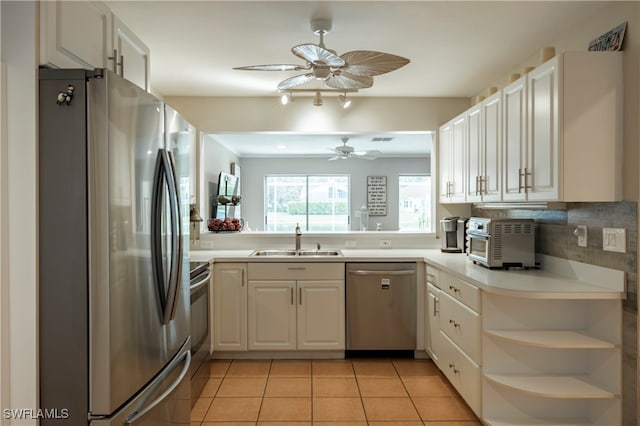 kitchen featuring white cabinetry, light tile patterned floors, appliances with stainless steel finishes, and sink