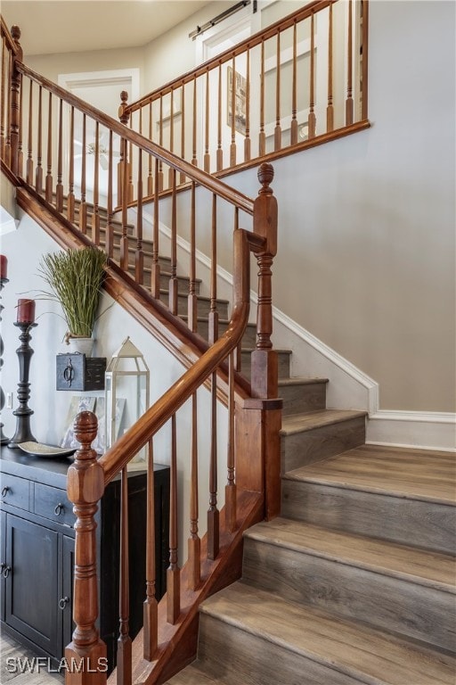 stairs with hardwood / wood-style floors