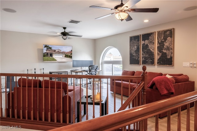 stairs with hardwood / wood-style flooring and ceiling fan