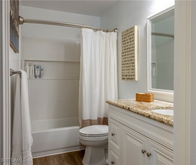 full bathroom featuring vanity, hardwood / wood-style floors, shower / tub combo, and toilet