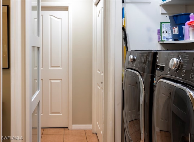 washroom with light tile patterned flooring and washer and clothes dryer