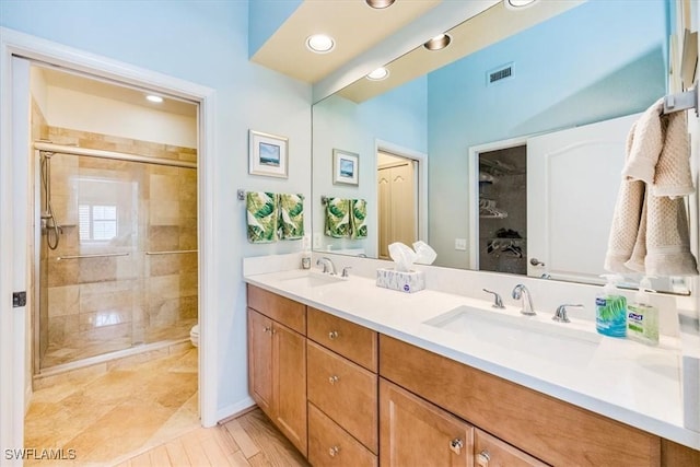 7725 Pebble Creek Cir Unit 8-303, Naples, FL 34108 - full bathroom with double vanity, a shower stall, toilet, and recessed lighting