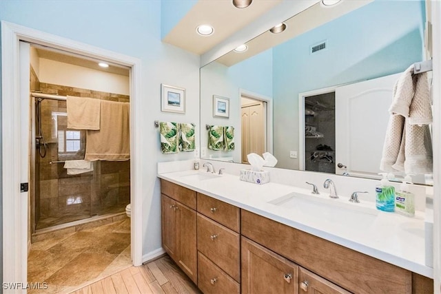 7725 Pebble Creek Cir Unit 8-303, Naples, FL 34108 - bathroom with double vanity, a shower stall, toilet, and recessed lighting