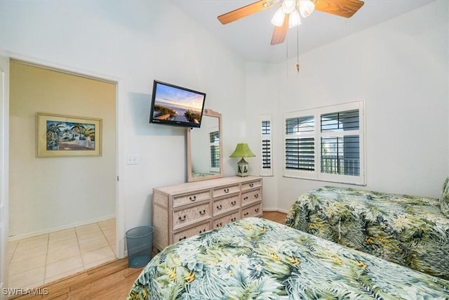 7725 Pebble Creek Cir Unit 8-303, Naples, FL 34108 - bedroom with light wood-style flooring, a ceiling fan, and baseboards