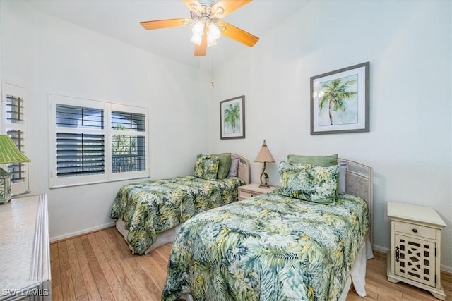 7725 Pebble Creek Cir Unit 8-303, Naples, FL 34108 - bedroom featuring wood finished floors, baseboards, and a ceiling fan