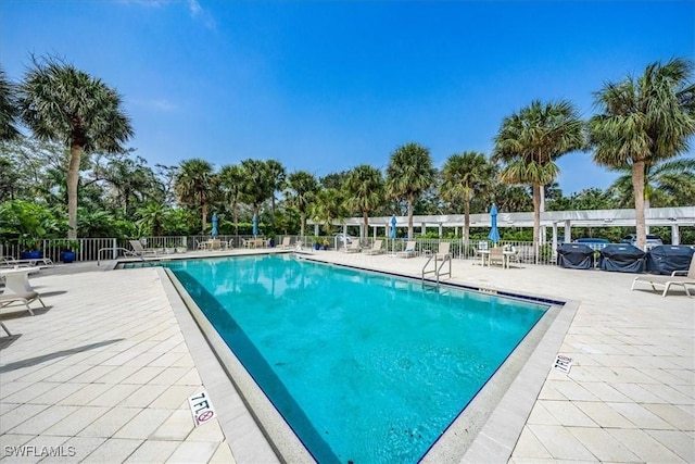 7725 Pebble Creek Cir Unit 8-303, Naples, FL 34108 - community pool with a patio