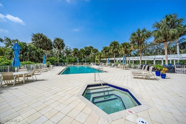 7725 Pebble Creek Cir Unit 8-303, Naples, FL 34108 - community pool featuring a community hot tub and a patio area