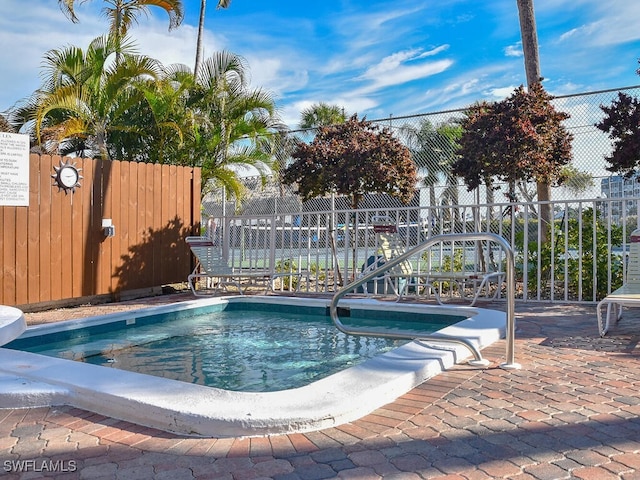 view of swimming pool with a swimming pool and fence