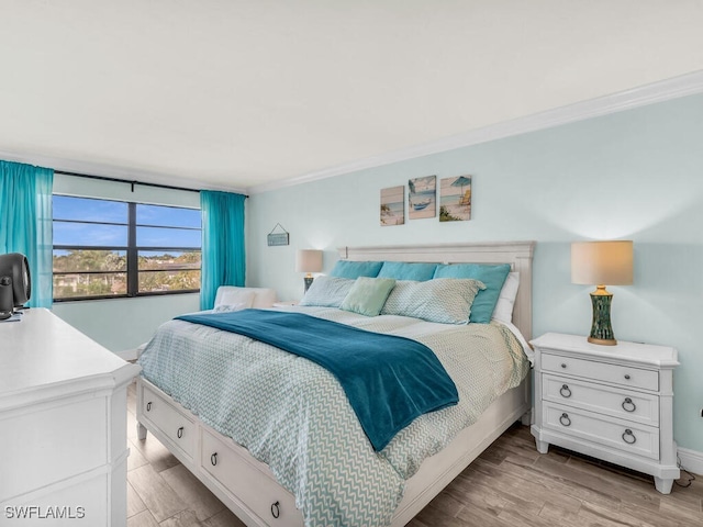 bedroom featuring light wood-style floors and ornamental molding