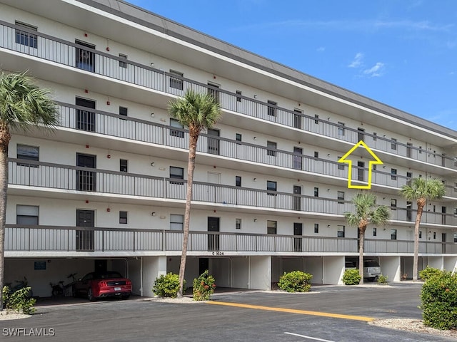 view of building exterior with parking