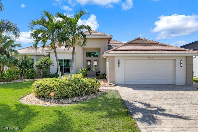 view of front of home featuring a garage and a front lawn