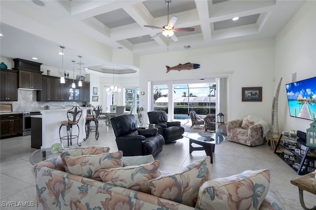 tiled living room featuring beamed ceiling, coffered ceiling, ceiling fan with notable chandelier, and a high ceiling