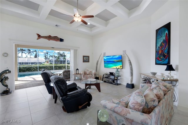 tiled living room featuring a towering ceiling, beamed ceiling, coffered ceiling, and ceiling fan