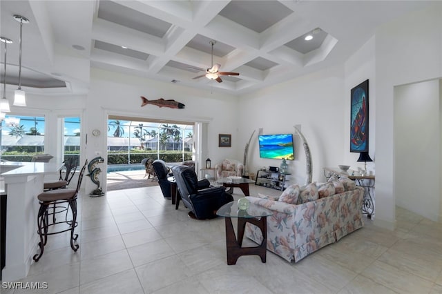 living room with ceiling fan, coffered ceiling, a towering ceiling, and beamed ceiling