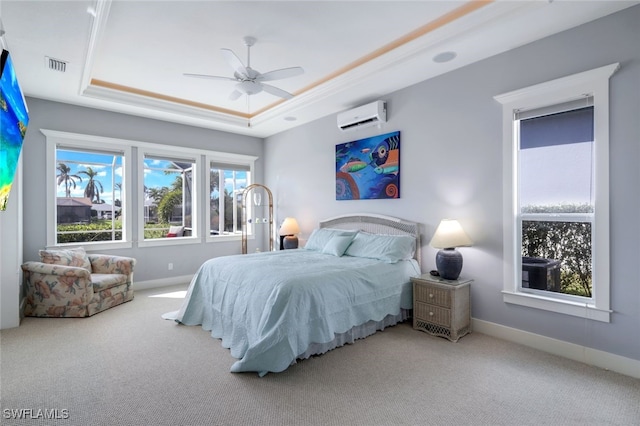 bedroom with carpet floors, a wall mounted AC, a tray ceiling, and ceiling fan