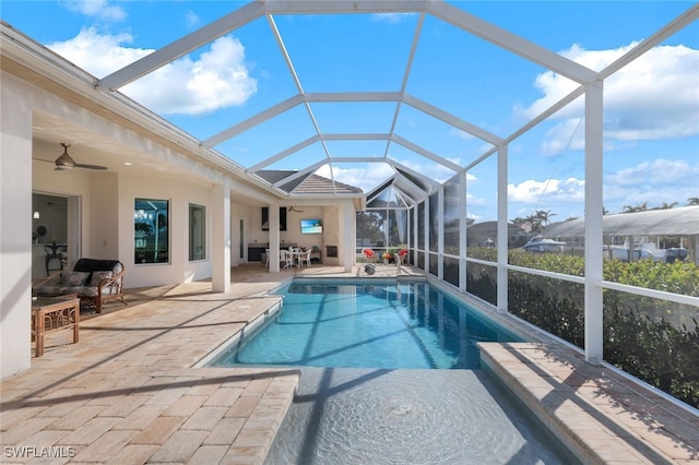 view of pool featuring a lanai, a patio, and ceiling fan