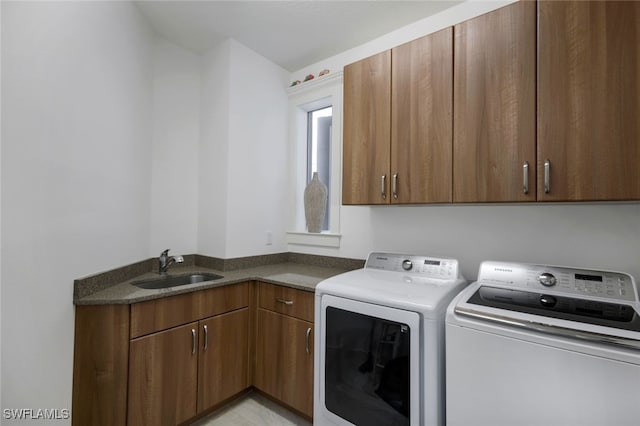 laundry room featuring washer and dryer, cabinets, and sink