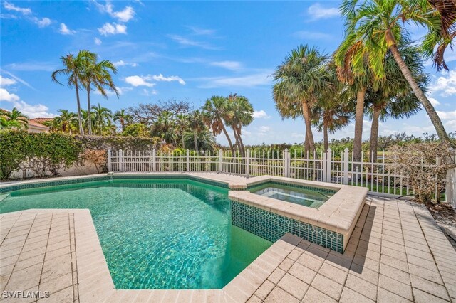 view of pool featuring an in ground hot tub