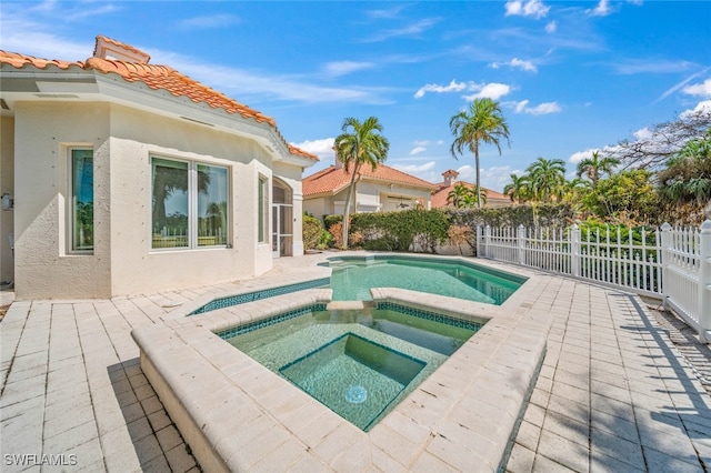 view of pool featuring a patio area and an in ground hot tub