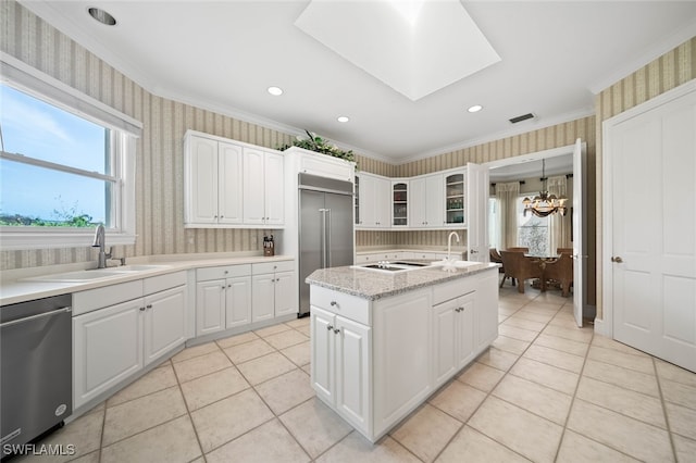 kitchen with sink, white cabinetry, appliances with stainless steel finishes, and ornamental molding