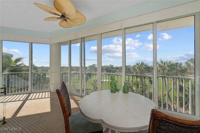 sunroom / solarium featuring a wealth of natural light and ceiling fan