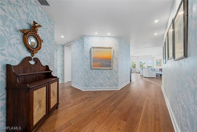 corridor with hardwood / wood-style flooring