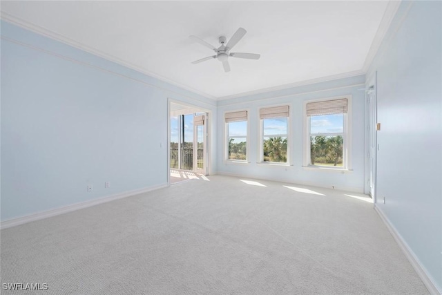 unfurnished room featuring ceiling fan, light colored carpet, and crown molding