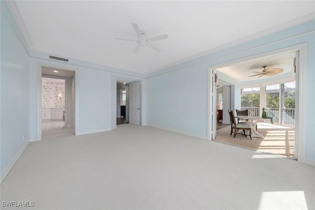 carpeted spare room featuring ceiling fan and ornamental molding