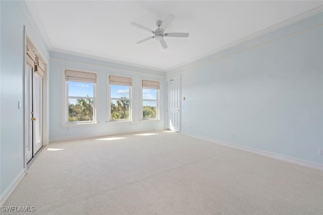 unfurnished room with light colored carpet, ceiling fan, and ornamental molding