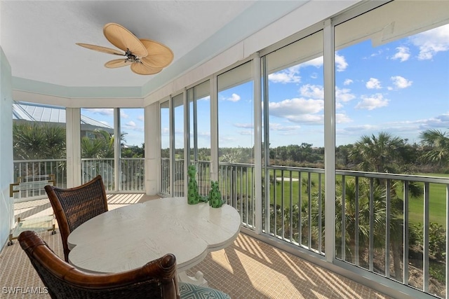 sunroom featuring ceiling fan