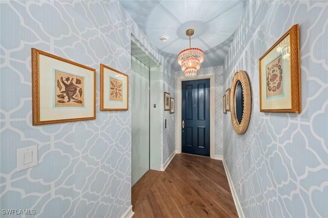 interior space with a chandelier and wood-type flooring