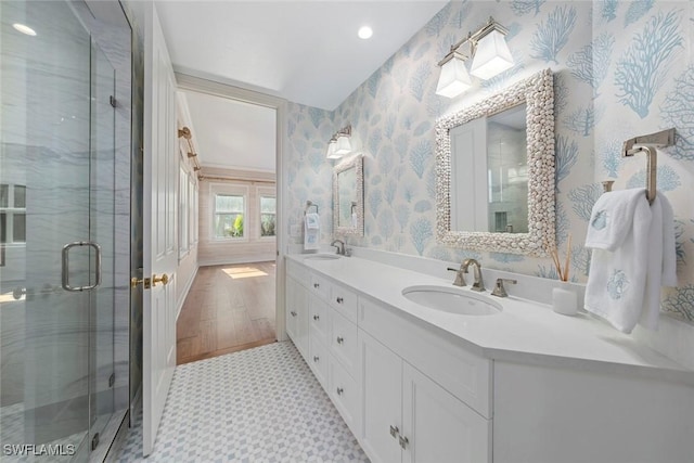 bathroom with hardwood / wood-style floors, vanity, and an enclosed shower