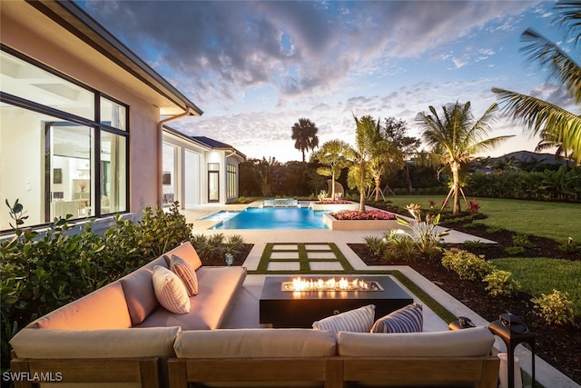 pool at dusk featuring a fire pit