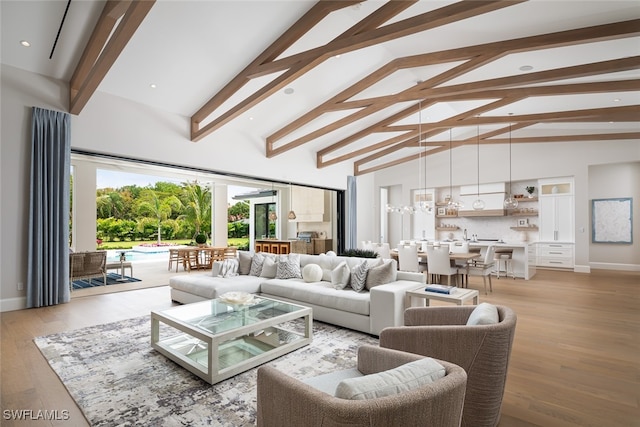 living room featuring beamed ceiling, light hardwood / wood-style floors, and high vaulted ceiling