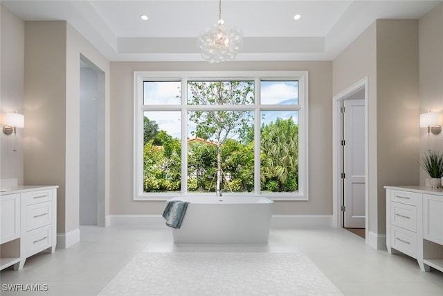 bathroom featuring a raised ceiling and plenty of natural light