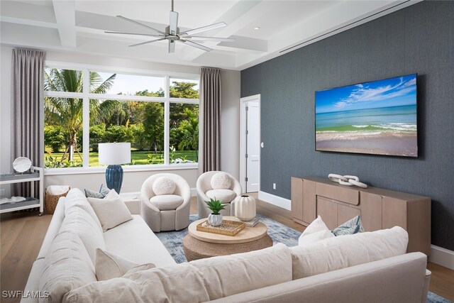 living room with beamed ceiling, hardwood / wood-style floors, and ceiling fan