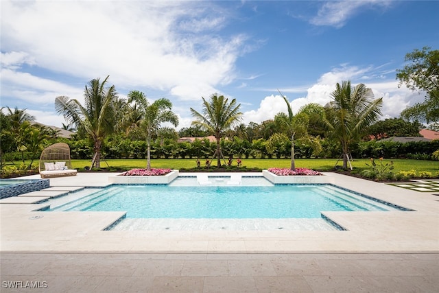 view of pool with a patio area and a lawn