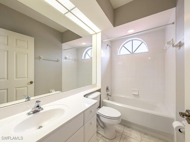 full bathroom with vanity, toilet, tiled shower / bath combo, and tile patterned flooring