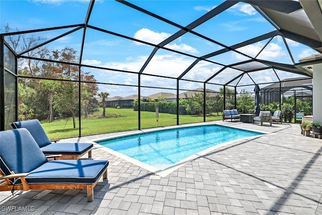 view of swimming pool featuring a yard, a patio, and glass enclosure