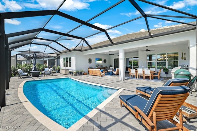 view of swimming pool featuring a lanai, an outdoor hangout area, a patio area, and ceiling fan