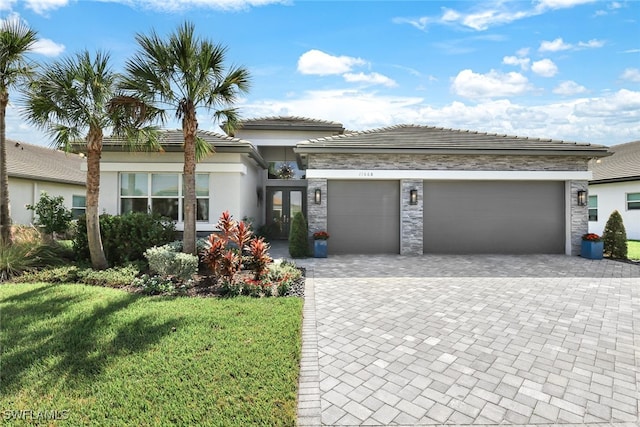 view of front facade with a front yard and a garage