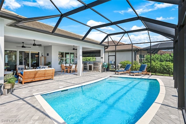 view of swimming pool with a patio, outdoor lounge area, a lanai, and ceiling fan