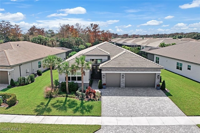 view of front of home with a front yard and a garage