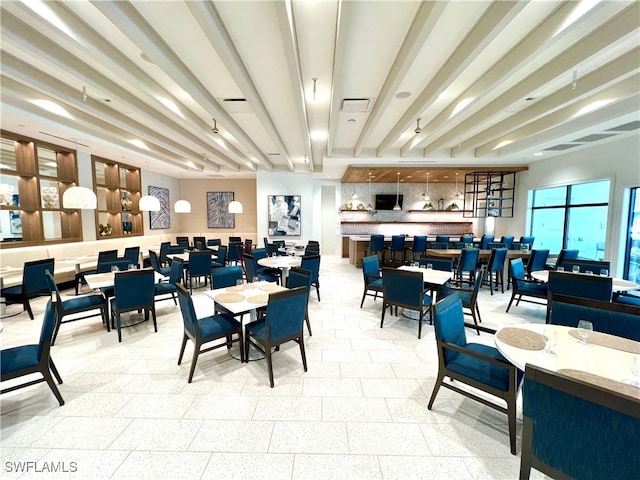 dining area featuring beamed ceiling