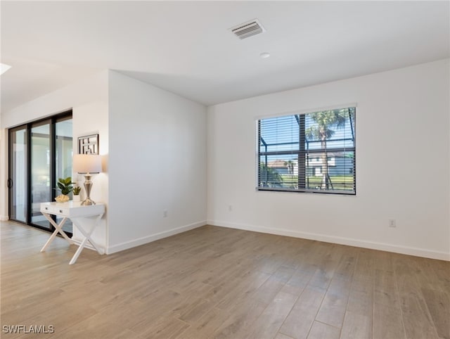 empty room with light hardwood / wood-style flooring