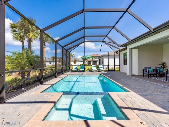 view of swimming pool featuring glass enclosure and a patio area