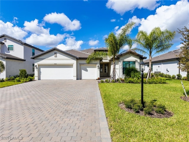 view of front of house with a front yard and a garage