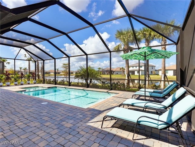 view of swimming pool with glass enclosure and a patio